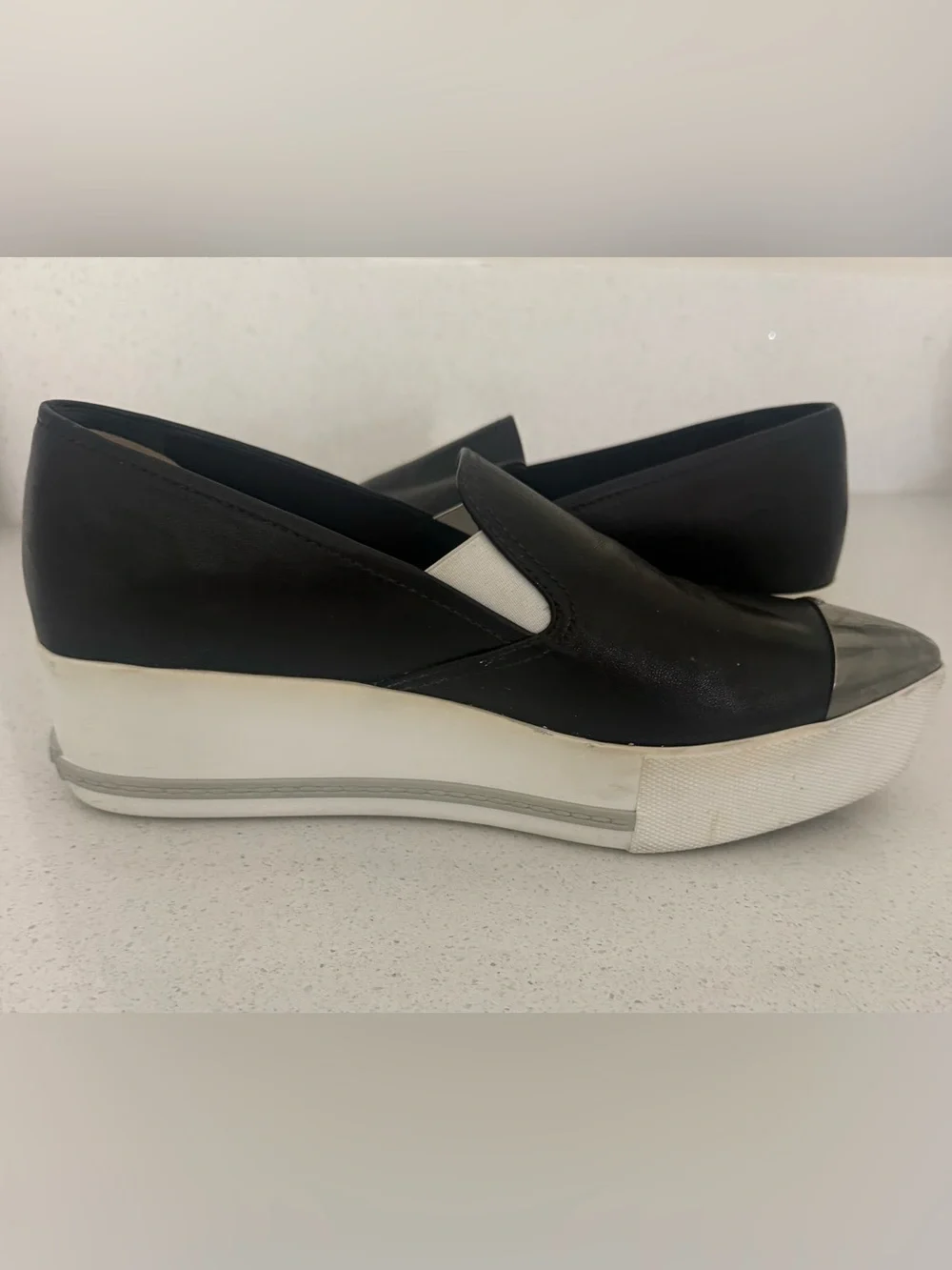 Miu Miu Black Leather Slip-On Sneakers with Silver Cap Toe